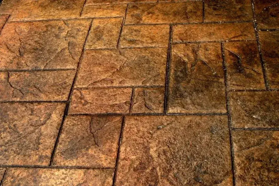 Close-up of brown ashlar-pattern stamped concrete